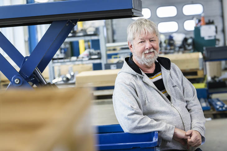 Flemming Pedersen, de pie orgullosamente en su recientemente renovada sala de producción, es un testimonio viviente del poder transformador de los principios Lean y un compromiso con la seguridad y la eficiencia.